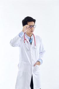 Mid adult man standing against white background