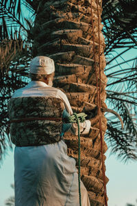 Rear view of man standing against building