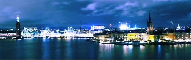 Boats in river with city in background