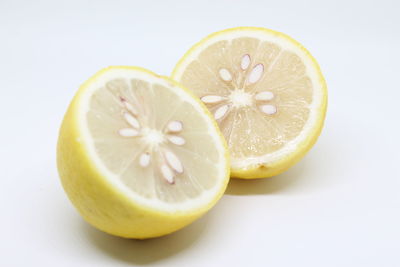 Close-up of lemon slice over white background