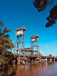 Low angle view of water tower against clear blue sky
