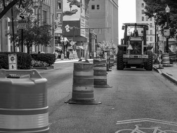 Vehicles on road against buildings in city