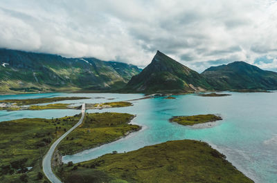 Road with bridges, islands, turquoise ocean and mountain peaks in lofoten, norway