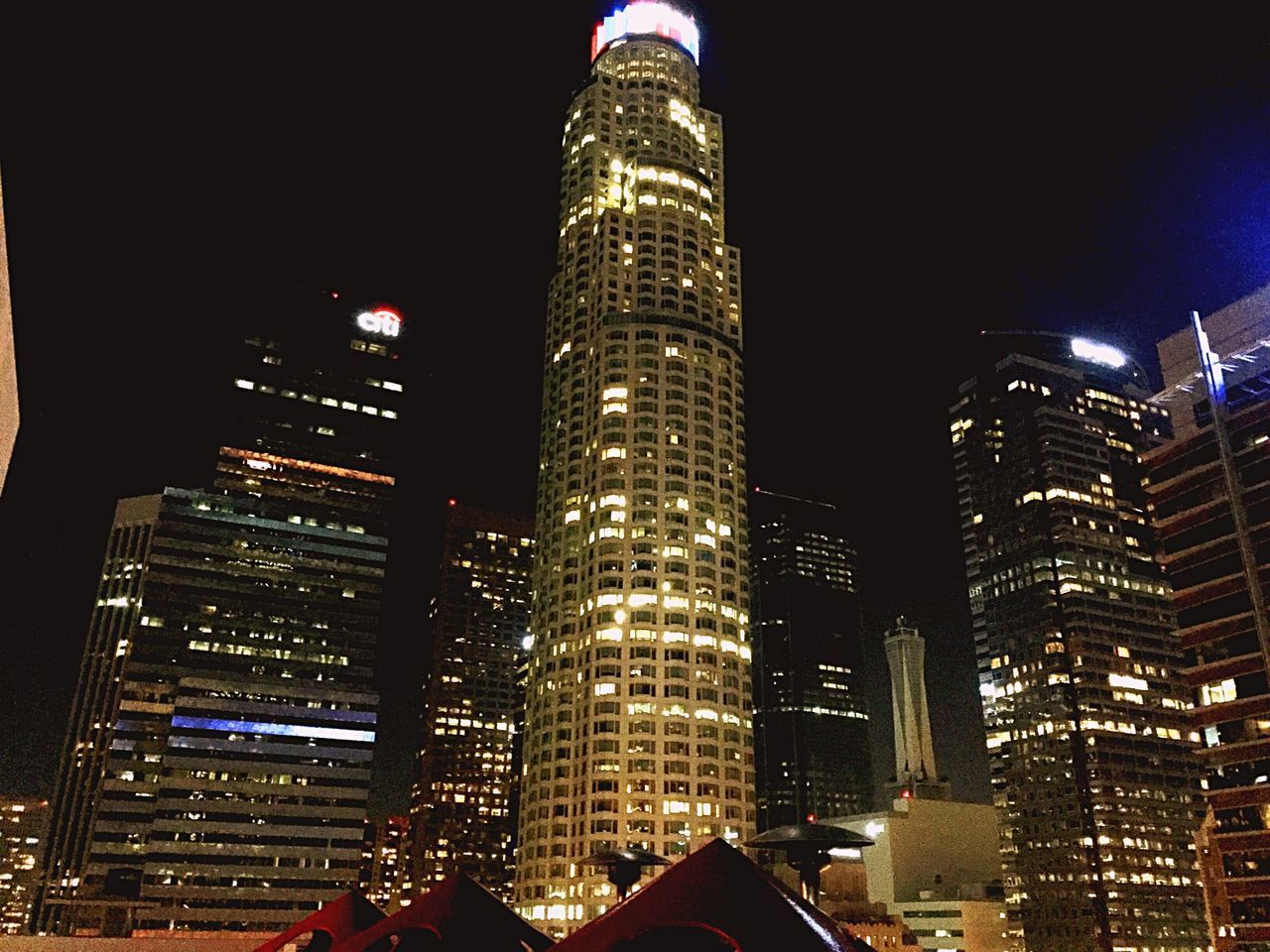 LOW ANGLE VIEW OF ILLUMINATED SKYSCRAPERS IN CITY