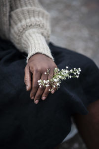 High angle view of woman holding flower