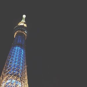 Low angle view of illuminated tower at night