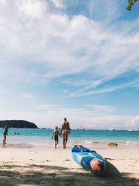People on beach against sky