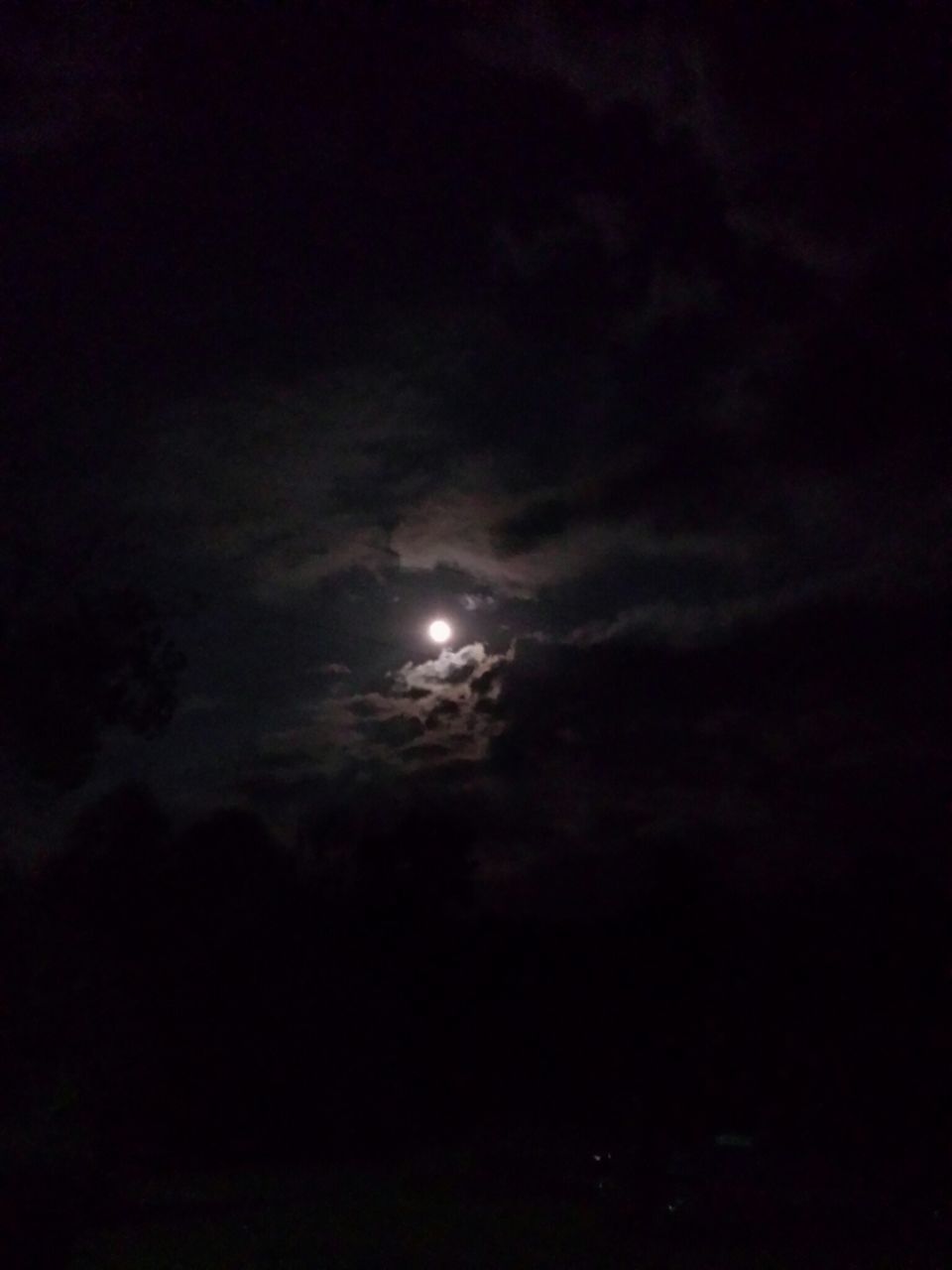 sky, night, beauty in nature, scenics, tranquility, low angle view, tranquil scene, moon, nature, dark, cloud - sky, astronomy, idyllic, sky only, weather, majestic, cloudy, moonlight, overcast, full moon