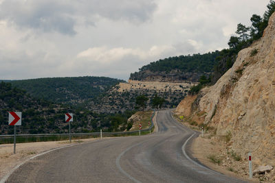 Empty road with mountains in background