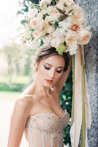 Portrait of young woman holding bouquet