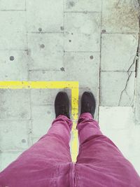 Low section of man standing on tiled floor