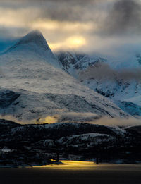 Scenic view of snow covered mountains against sky
