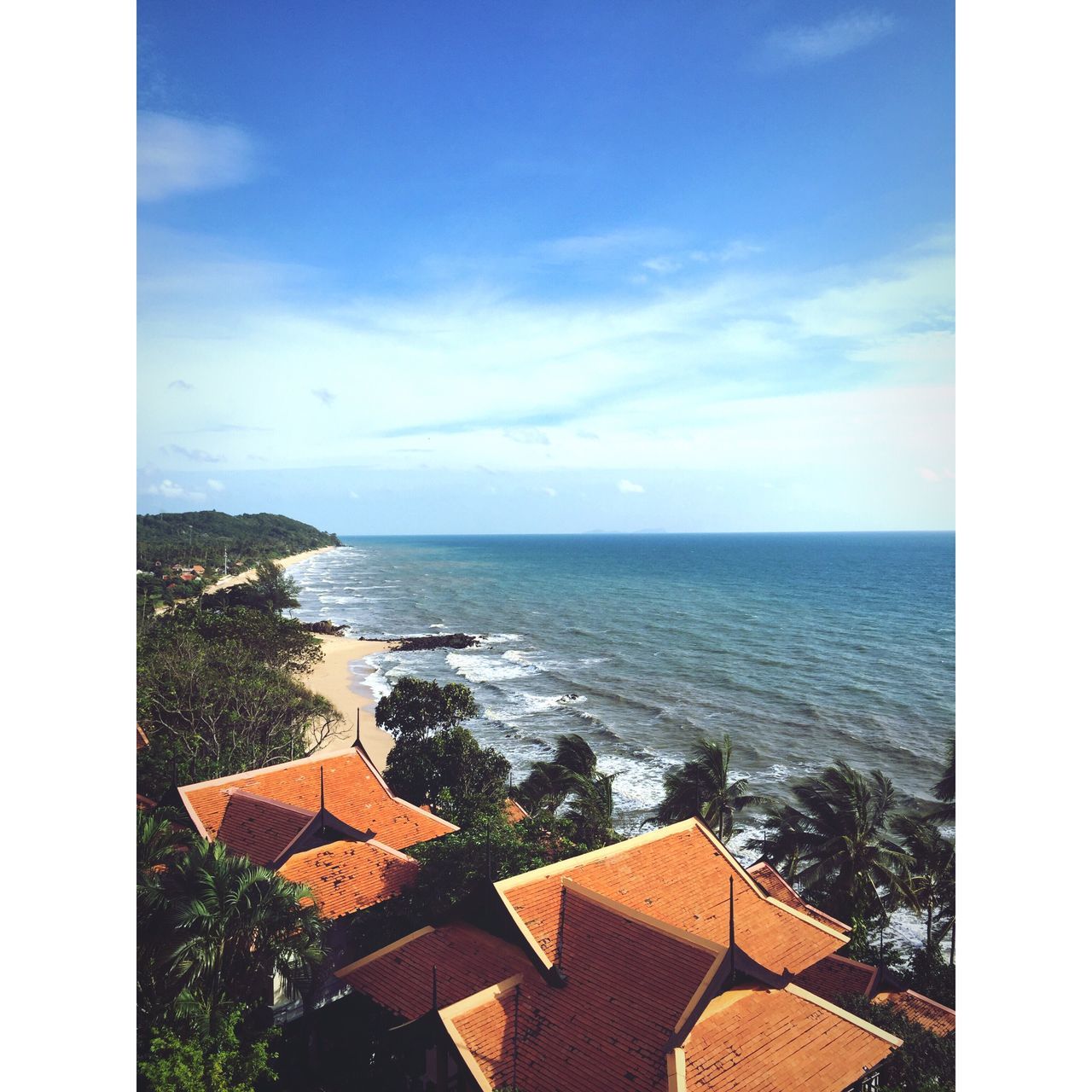 sea, horizon over water, water, auto post production filter, transfer print, architecture, built structure, blue, building exterior, sky, house, high angle view, tranquil scene, shore, scenics, beauty in nature, tranquility, roof, day, cloud, outdoors, nature, cloud - sky, ocean, no people, remote, town