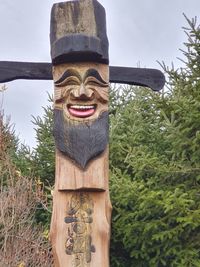 Low angle view of statue against trees