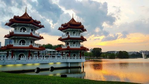 Reflection of building in lake during sunset