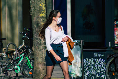 Full length of woman with bicycle