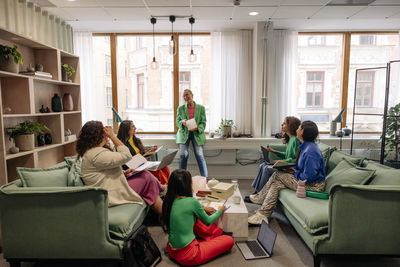 Happy female entrepreneurs enjoying during business meeting at office