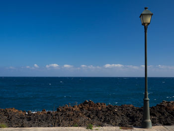 Scenic view of sea against blue sky