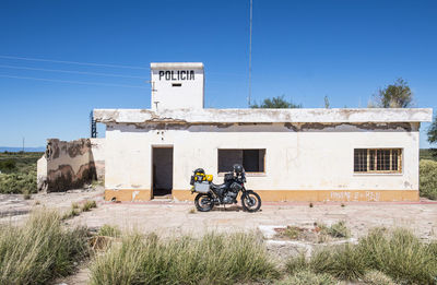 Touring motorbike parked in front of abandoned police station