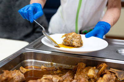 Midsection of man preparing food