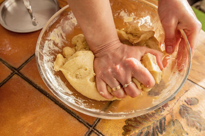 Midsection of woman preparing food in bowl on table