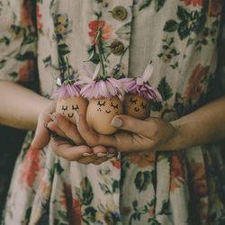 Midsection of woman holding eggs