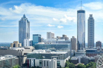 Modern buildings in city against sky