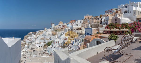 Buildings in city against clear sky