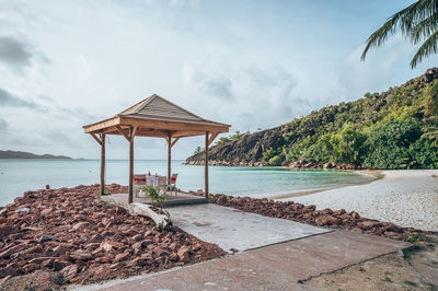 Gazebo by sea against sky