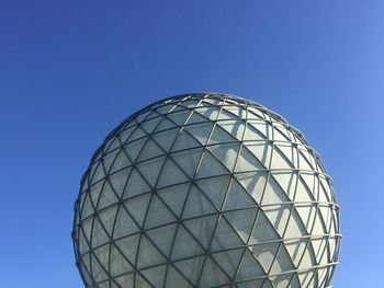 Low angle view of modern building against blue sky