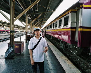 Portrait of man standing on railroad station platform