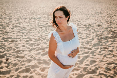 Mid adult woman standing on beach