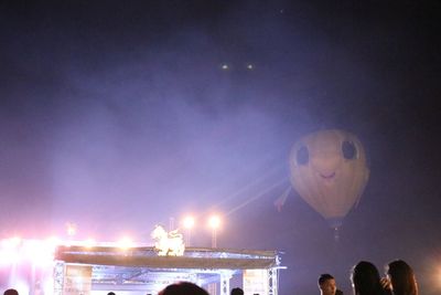 Illuminated lights against sky at night