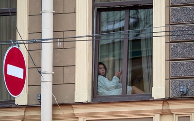 Full length of woman standing in front of building