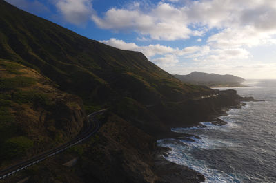 Scenic view of sea and mountains against sky