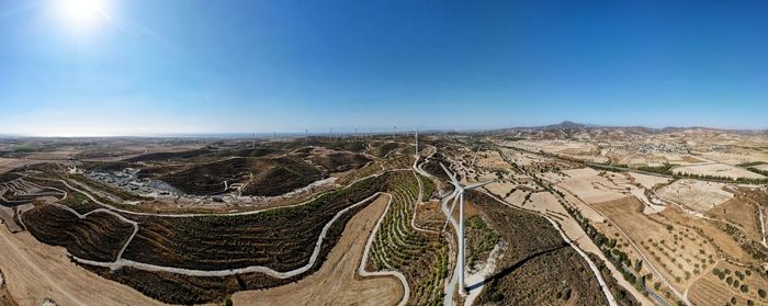 Panoramic view of land against clear blue sky