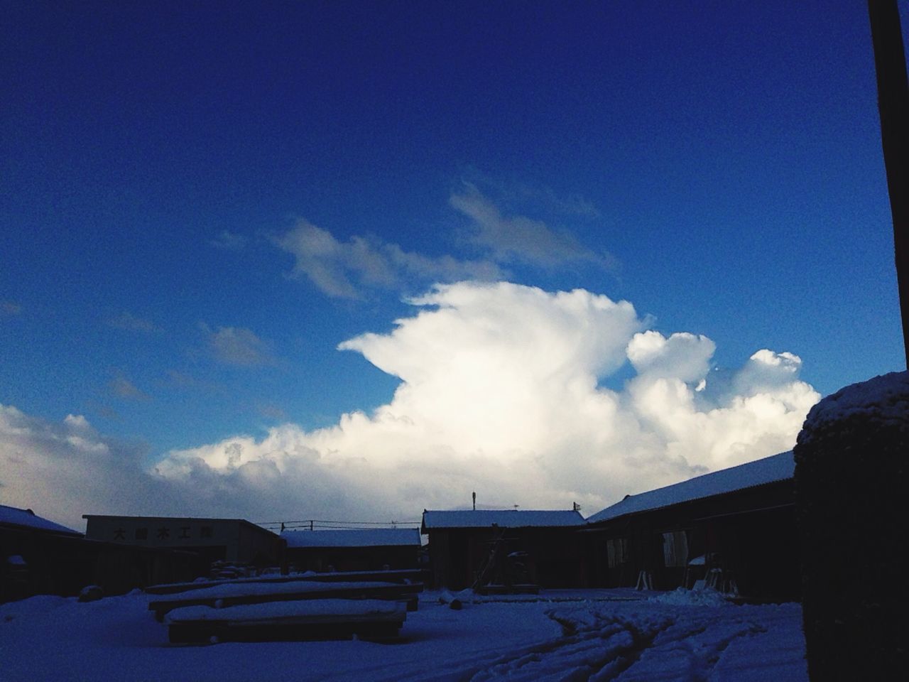 blue, sky, built structure, architecture, building exterior, cloud - sky, cloud, sunlight, winter, house, day, snow, low angle view, nature, outdoors, no people, cold temperature, copy space, weather, roof