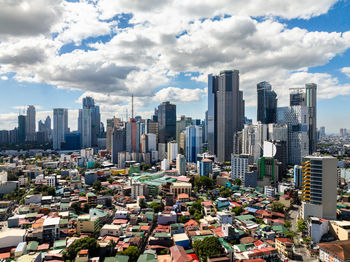 High angle view of cityscape against cloudy sky