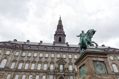 Low angle view of building against cloudy sky