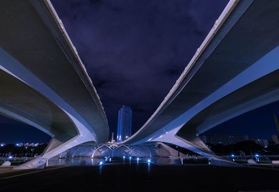 Low angle view of suspension bridge over river at night