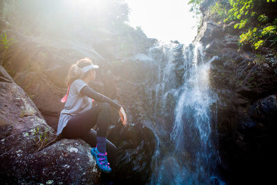 People sitting on rock in forest