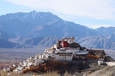 High angle view of townscape and mountains against sky