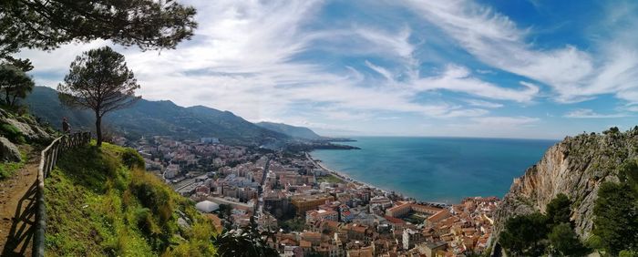 High angle view of sea and cityscape against sky