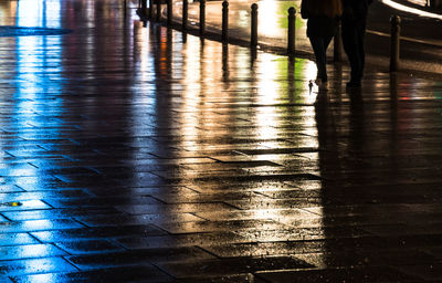 Low section of woman walking on wet floor