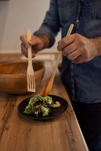 Midsection of man preparing food