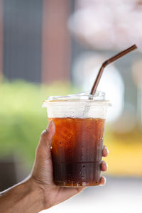 Close-up of hand holding drink