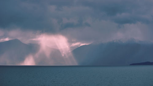 Scenic view of sea against storm clouds