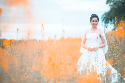 Portrait of woman standing on field