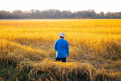 Rear view of man standing on field