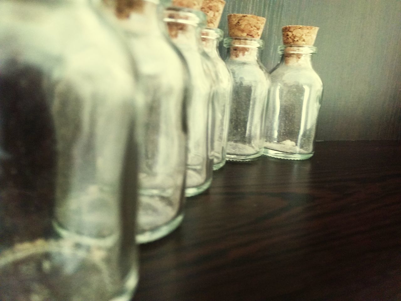 indoors, still life, table, close-up, glass - material, bottle, drinking glass, selective focus, wood - material, empty, transparent, no people, focus on foreground, drink, jar, home interior, wineglass, refreshment, food and drink, absence